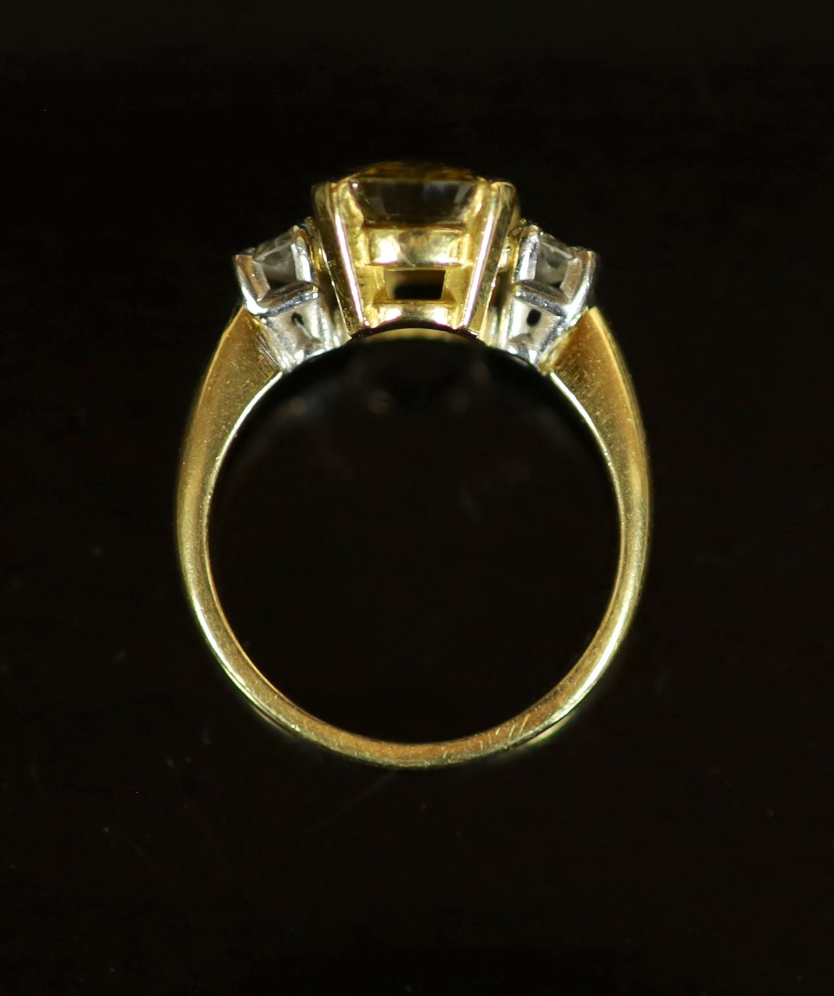 An 18ct gold, yellow sapphire and diamond set three stone ring